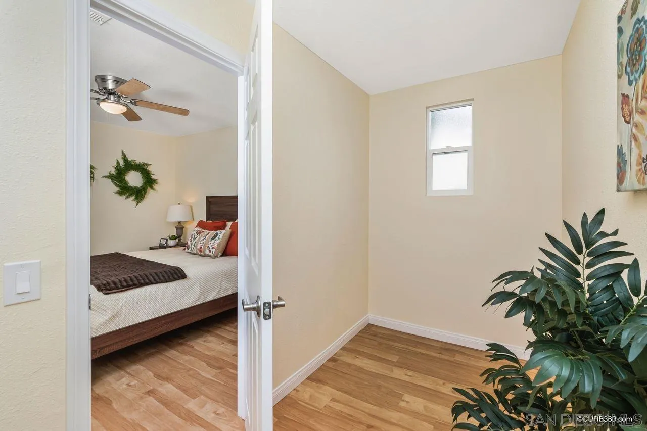 1427 Panorama Ridge Road Oceanside, CA 92056 - Photo 21 of 33 a bedroom with a bed and a potted plant