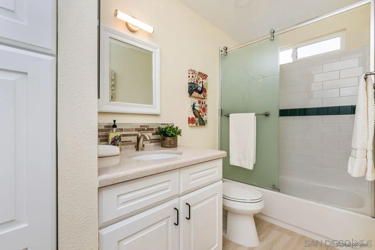 1427 Panorama Ridge Road Oceanside, CA 92056 - Photo 22 of 33 a bathroom with a sink a toilet and shower