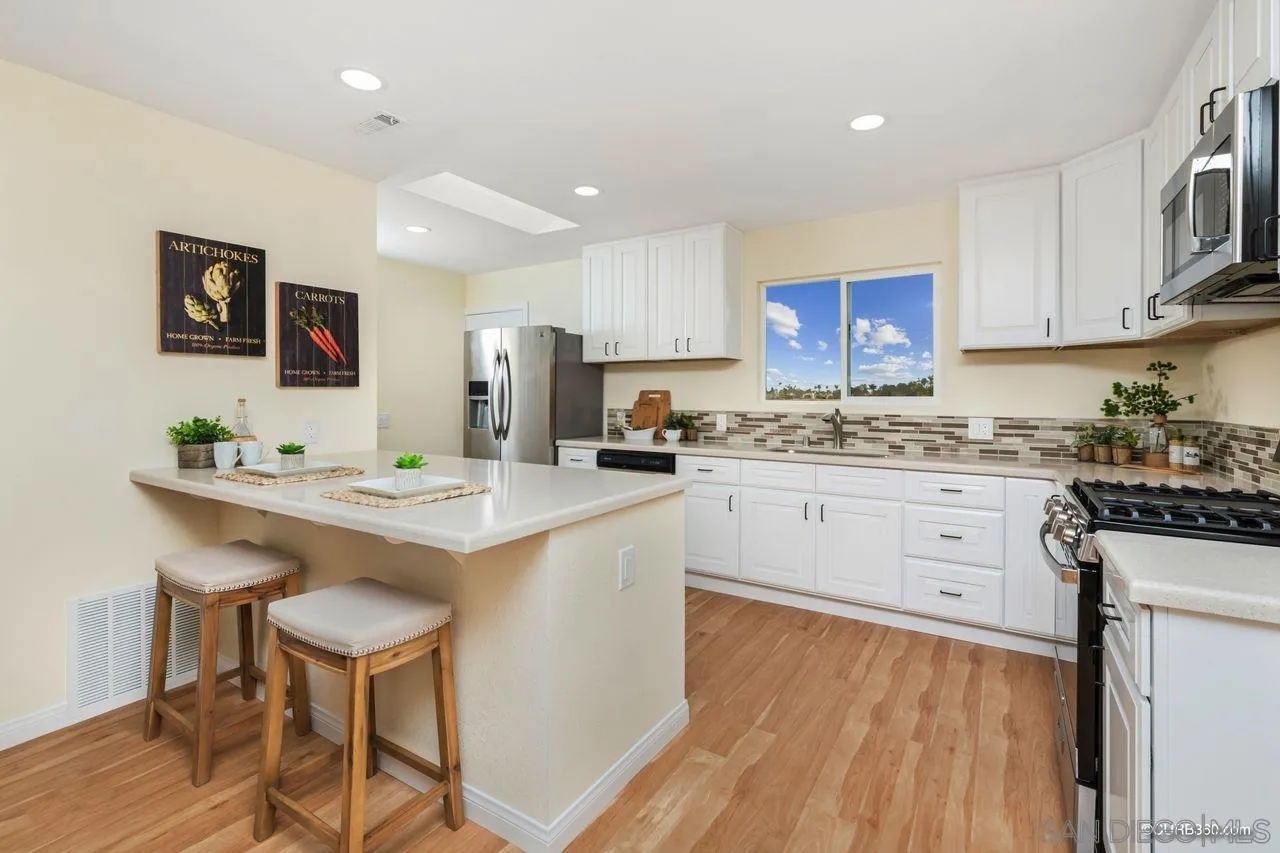 1427 Panorama Ridge Road Oceanside, CA 92056 - Photo 10 of 33 a kitchen with stainless steel appliances white cabinets and sink