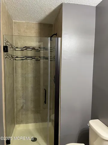 a bathroom with a glass shower door