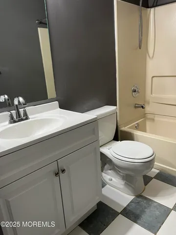 a bathroom with a toilet a sink and bathtub