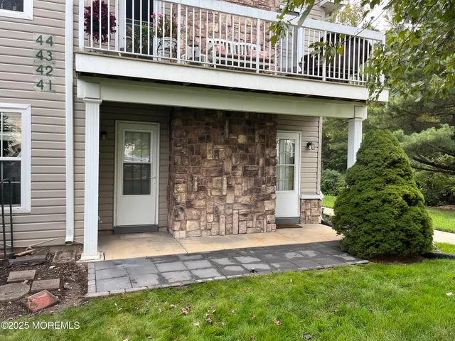 a view of front door of house with outdoor shower
