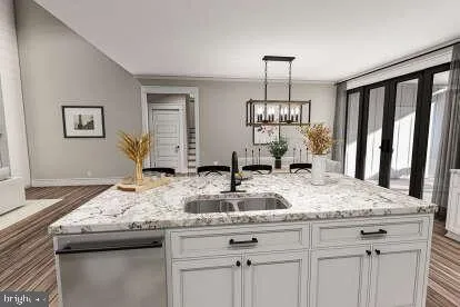 a kitchen with a granite countertop sink and wooden floor