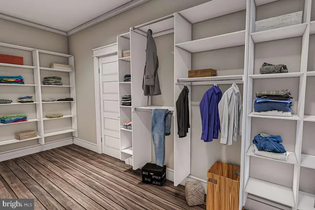 a view of walk in closet with clothes and shoes