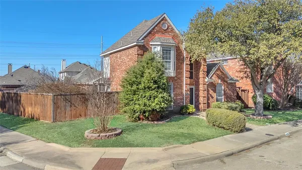 a front view of a house with a yard and a garage