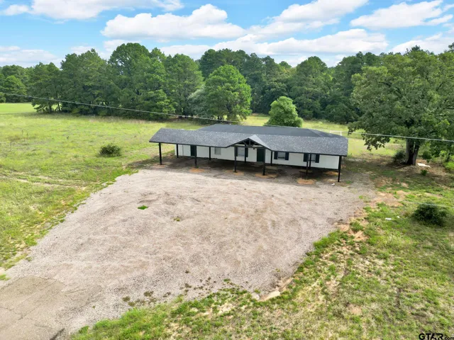 a view of a house with pool and lake view