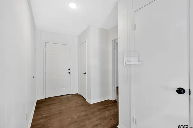 a kitchen with a sink dishwasher a stove and a refrigerator with wooden floor