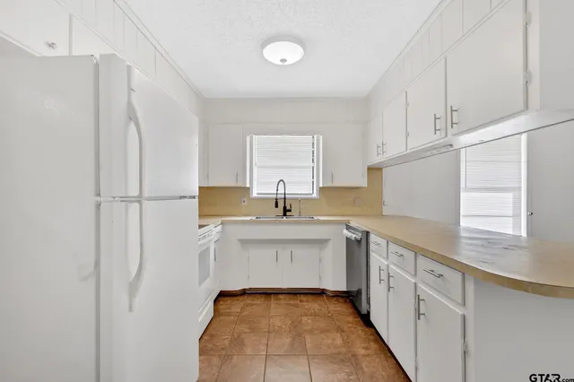 a kitchen with a sink stove and cabinets