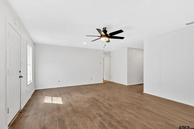 a view of a hallway with wooden shelves