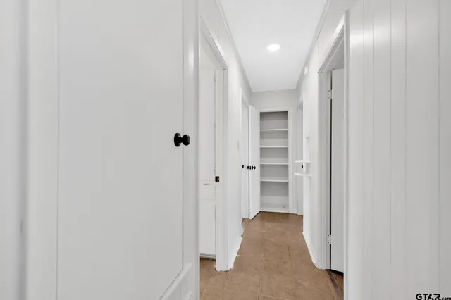 a spacious bathroom with a double vanity sink a mirror and a bathtub