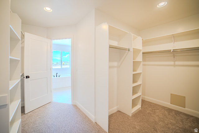 45 North Scarlet Maple Road, Unit 4317 Vineyard, UT 84059 - Photo 22 of 35 Walk-in closet featuring built-in shelving, hanging rods, recessed lighting, and carpet flooring