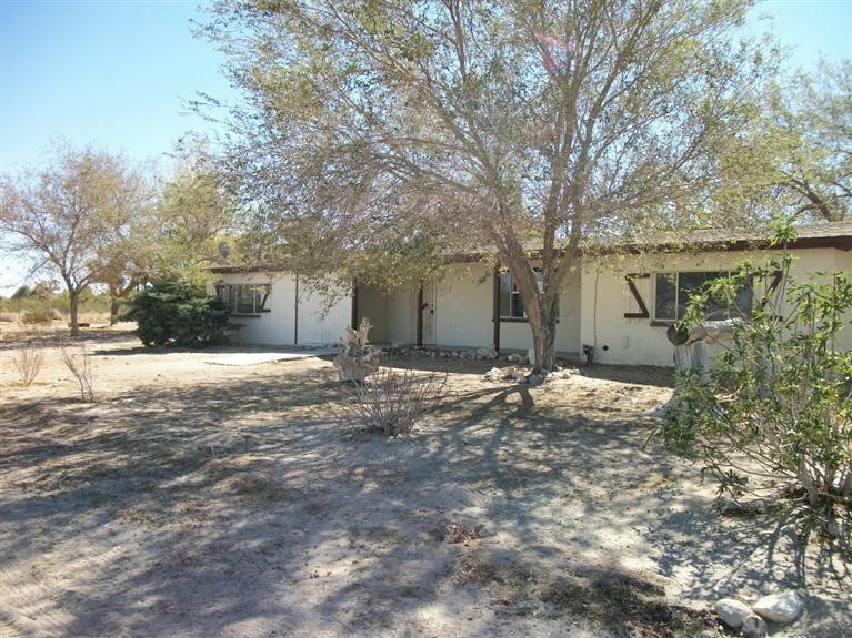 36025 Foothill Road Lucerne Valley, CA 92356 - Photo 1 of 1 a backyard of a house with large trees and outdoor seating