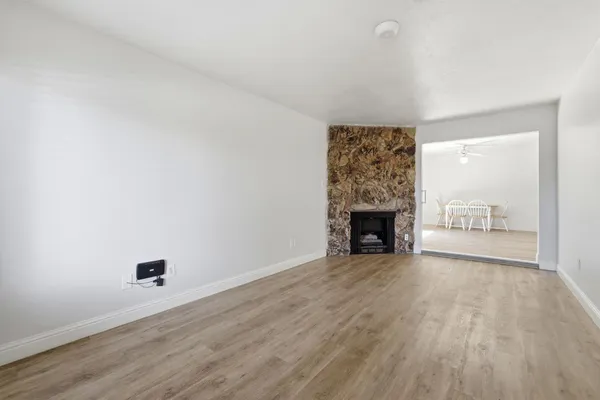 a view of an empty room and a fireplace