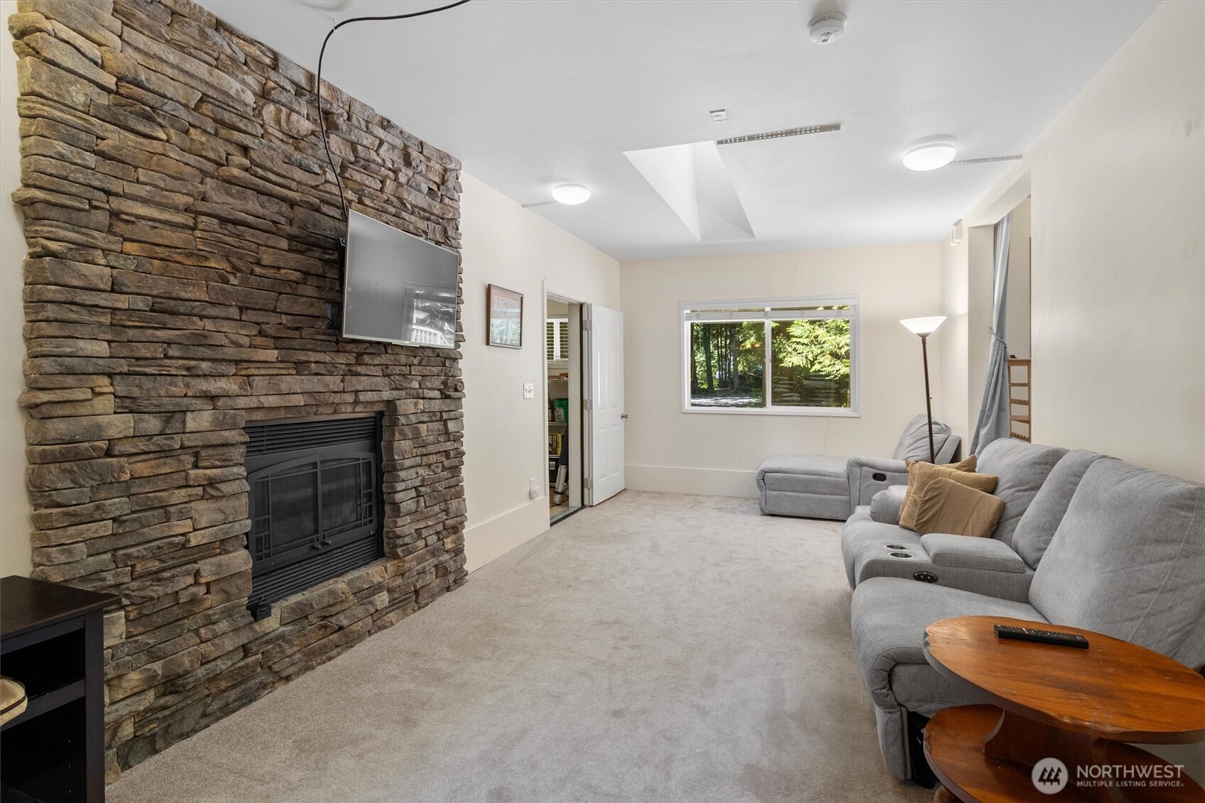 7036 Rainier Way Glacier, WA 98244 - Photo 16 of 39 a living room with furniture a flat screen tv and a fireplace