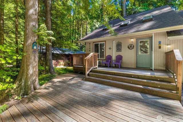 a view of house with backyard and outdoor seating