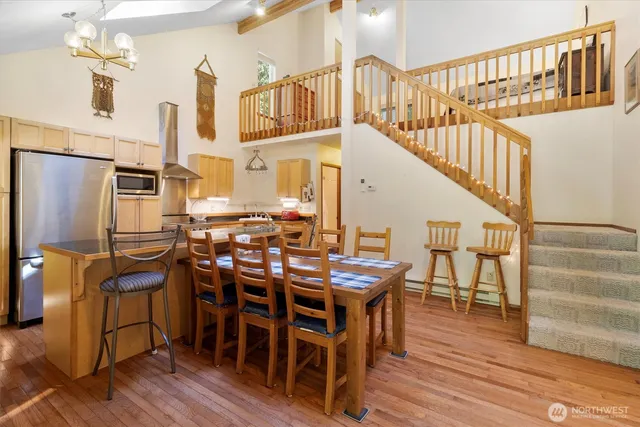 a view of a dining room with furniture and wooden floor