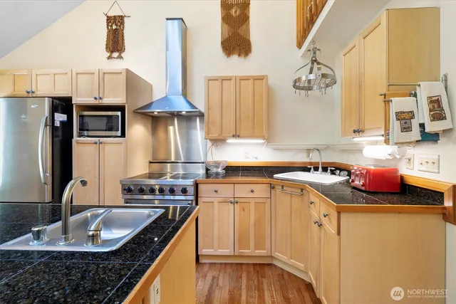 a kitchen with a sink a stove and cabinets