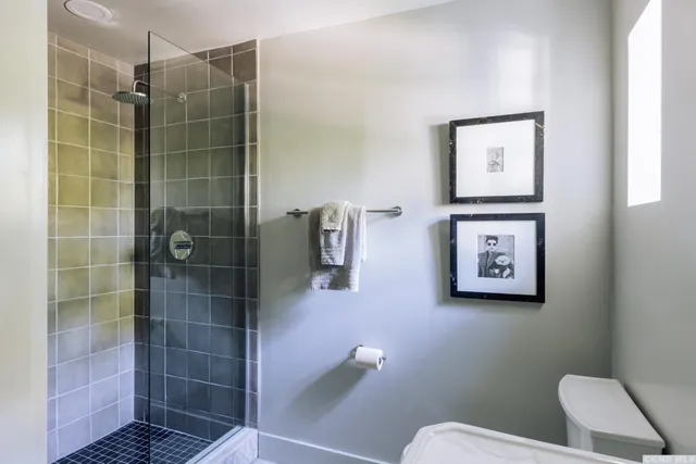 a bathroom with a toilet and a shower