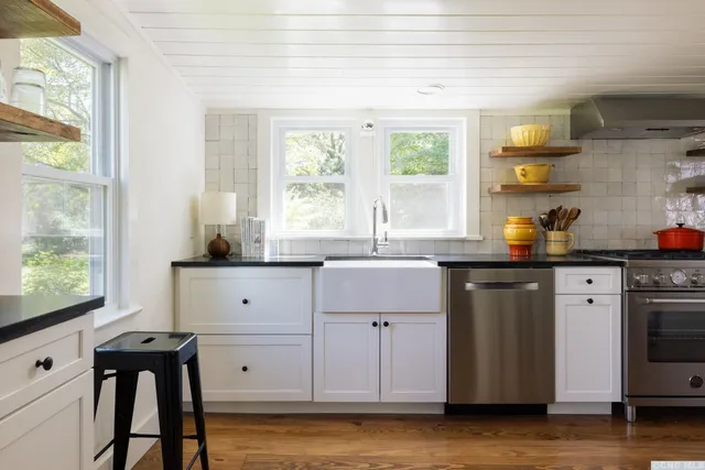 a kitchen with a sink cabinets and window