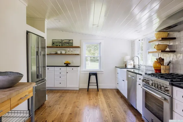 a kitchen with stainless steel appliances a stove a sink and a refrigerator