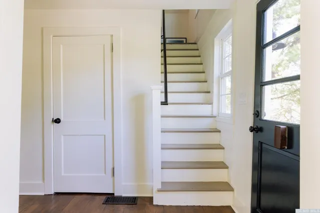 a view of entryway and hall with wooden floor