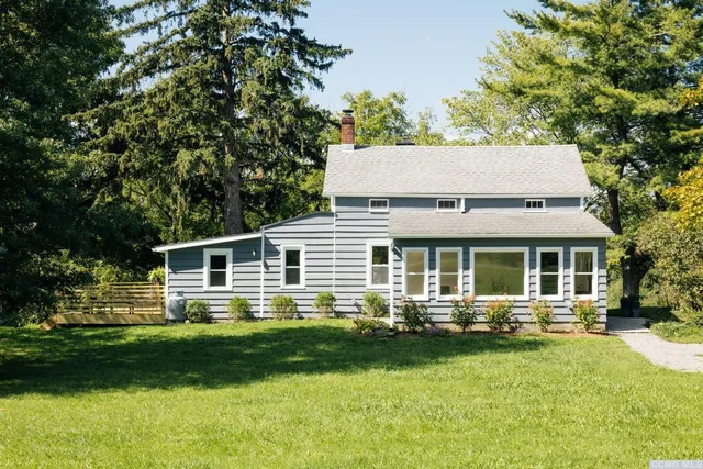 a front view of a house with a yard table and chairs