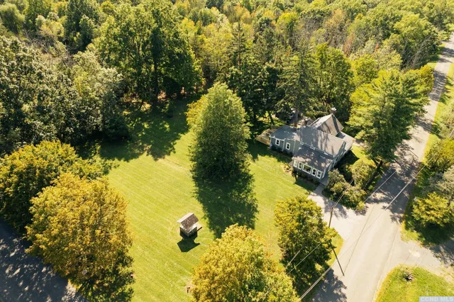 a view of lake from next to house with yard and green space