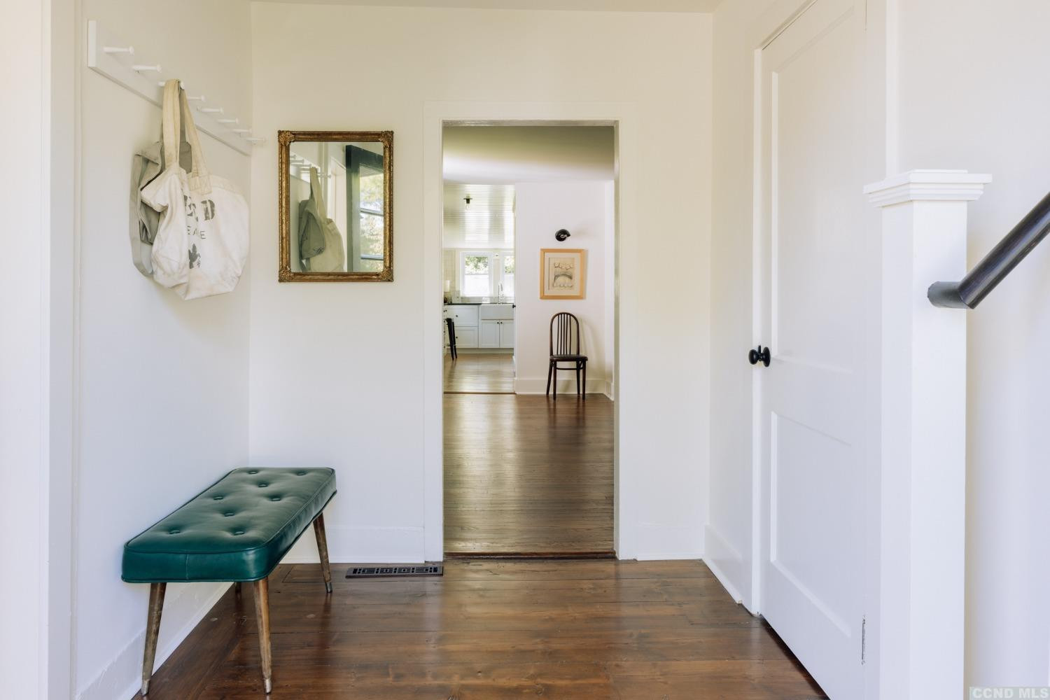 85 Roundtop Road Germantown, NY 12526 - Photo 4 of 31 a view of a hallway with wooden floor and a dining room