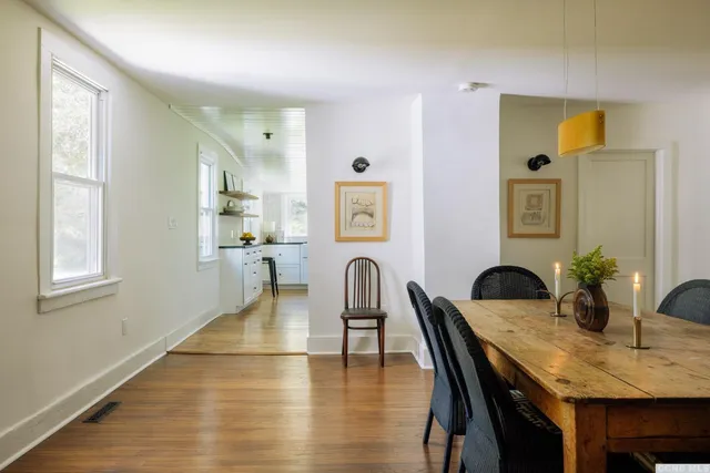 a dining room with furniture and window