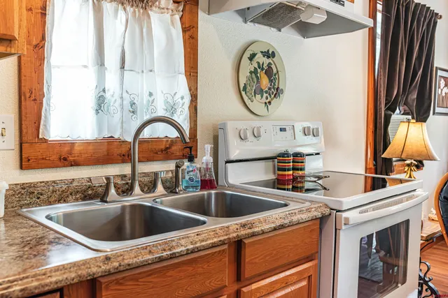 a kitchen with a sink and a stove with a sink