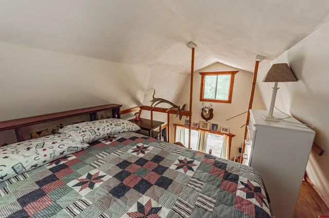 a bedroom with a bed a couch and dresser