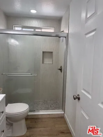 a bathroom with a shower a toilet and a shower