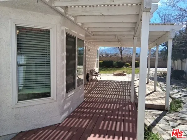 a view of a patio with table and chairs