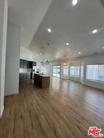 a kitchen with a wooden floor and window
