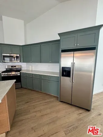 a kitchen with a refrigerator and a sink