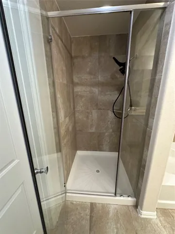 a bathroom with a shower and toilet