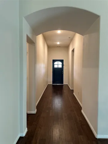 a view of wooden floor and windows in an empty room