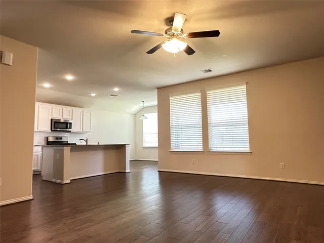 a view of kitchen with sink and wooden floor