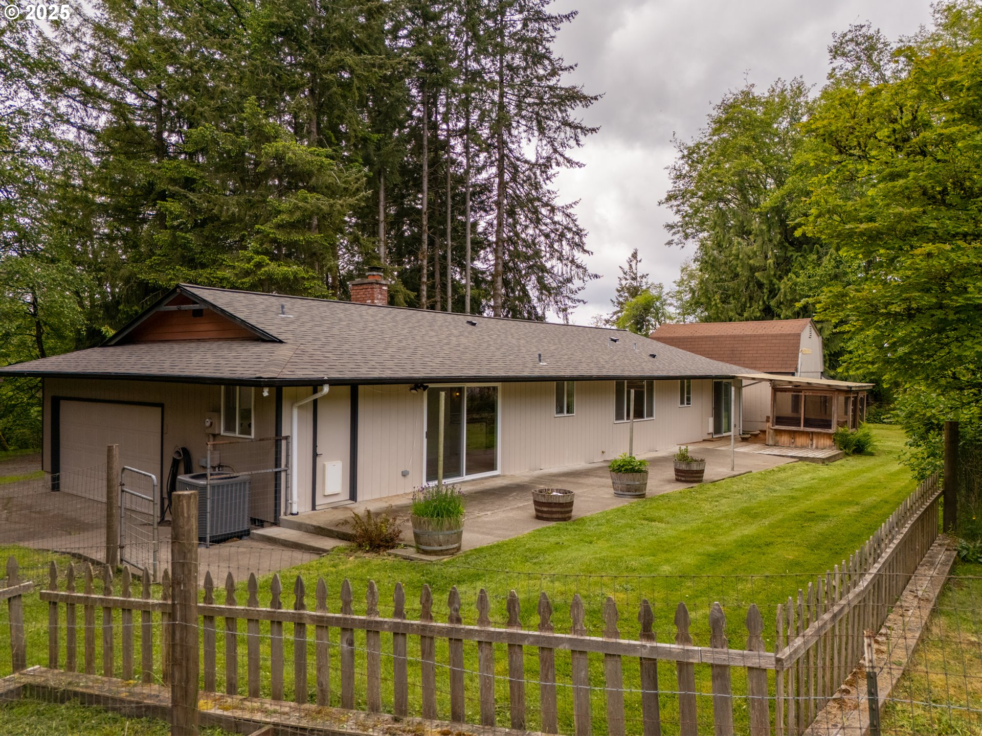 31052 Brownlee Road Rainier, OR 97048 - Photo 9 of 47 a view of a house with backyard sitting area and garden