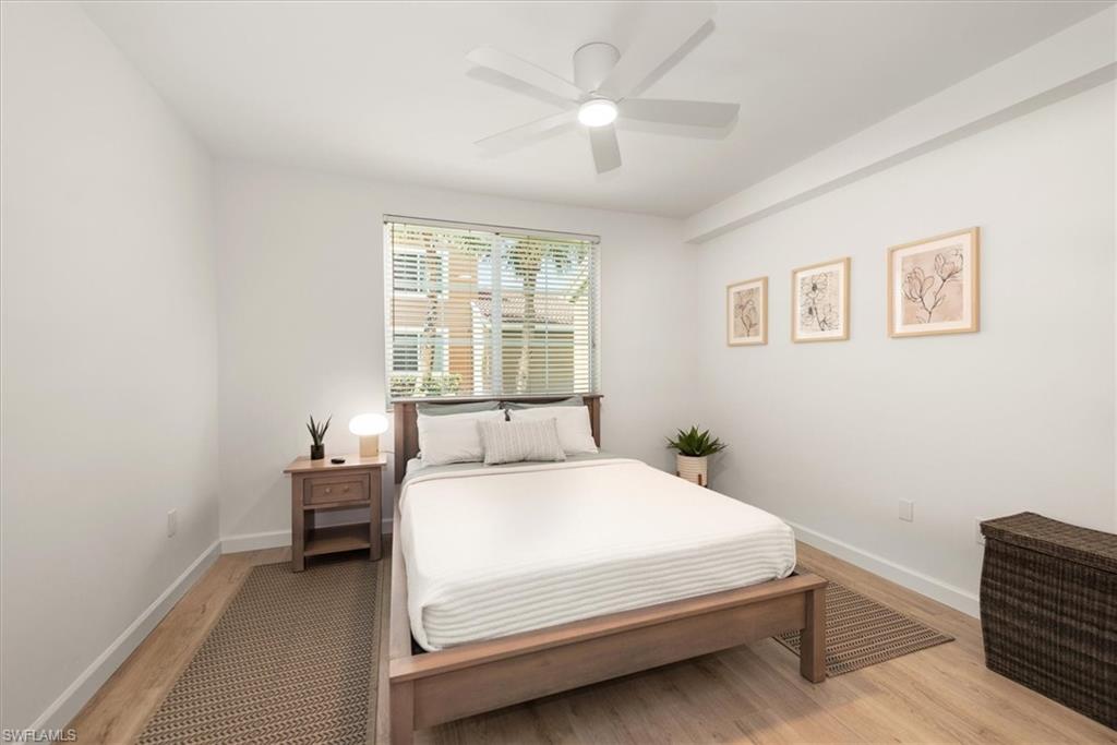 1170 Reserve Way, Unit 107 Naples, FL 34105 - Photo 17 of 47 Bedroom featuring light wood finished floors and ceiling fan