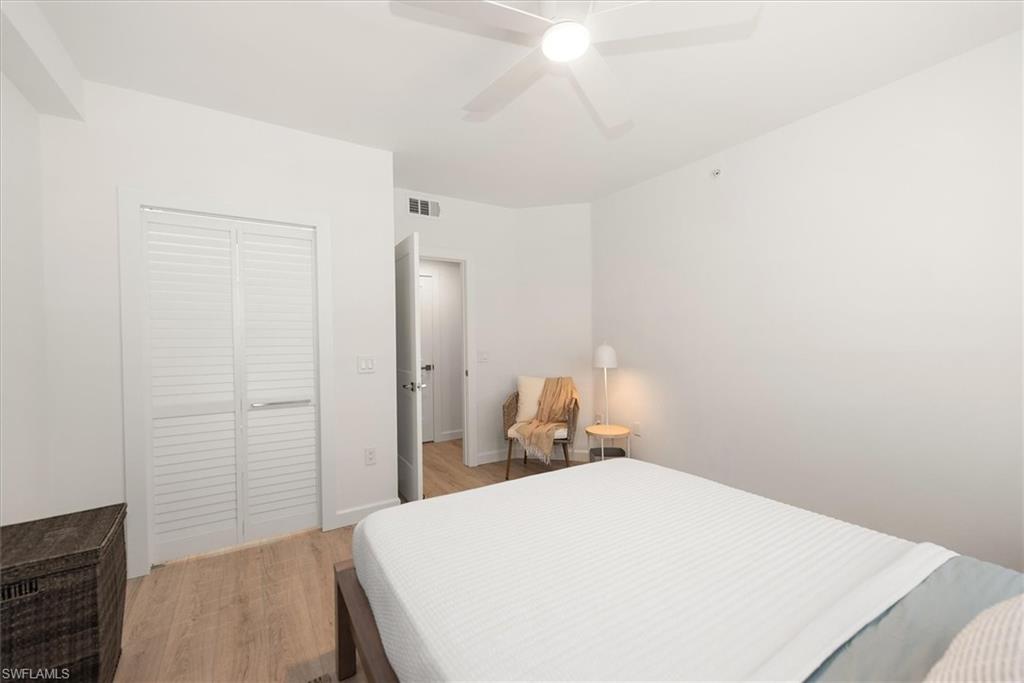 1170 Reserve Way, Unit 107 Naples, FL 34105 - Photo 18 of 47 Bedroom featuring light wood-style floors, a closet, and ceiling fan