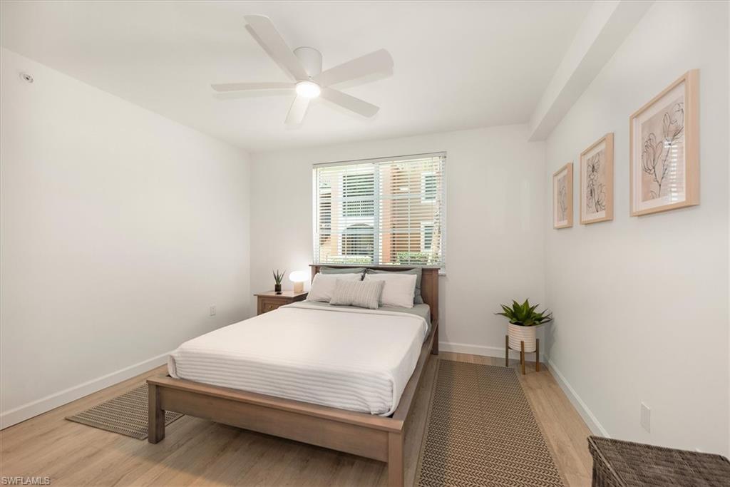 1170 Reserve Way, Unit 107 Naples, FL 34105 - Photo 19 of 47 Bedroom with light wood-type flooring and ceiling fan