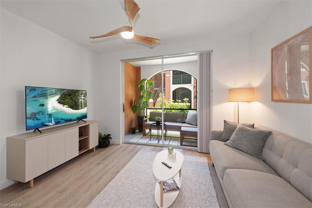 1170 Reserve Way, Unit 107 Naples, FL 34105 - Photo 2 of 47 Living area with wood finished floors and ceiling fan