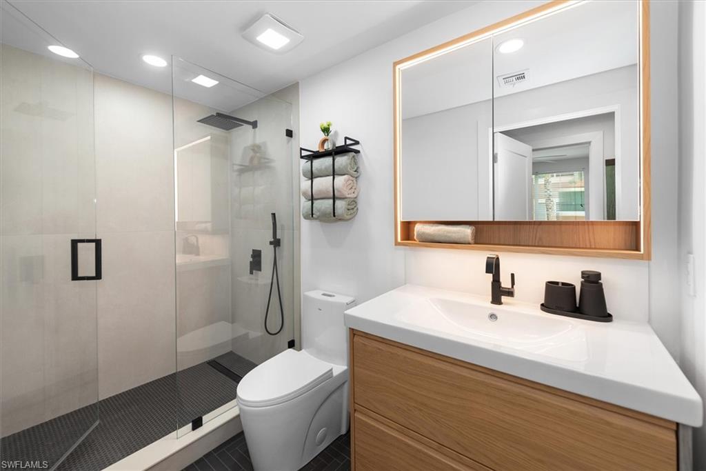 1170 Reserve Way, Unit 107 Naples, FL 34105 - Photo 22 of 47 Full bath featuring vanity, a stall shower, recessed lighting, and dark tile patterned floors
