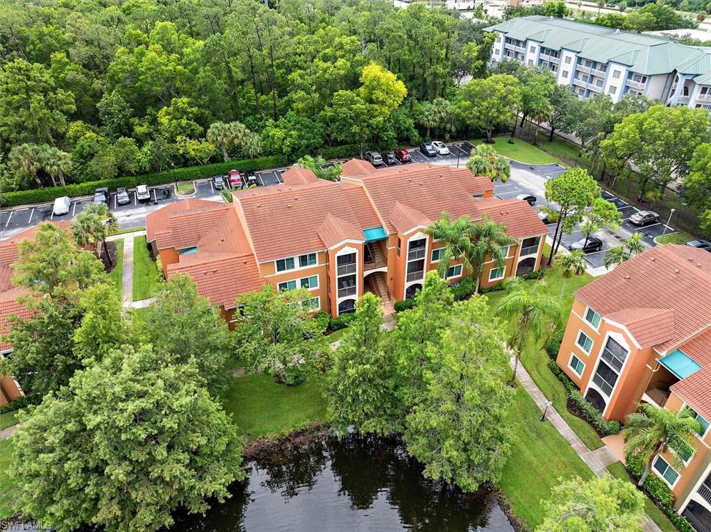1170 Reserve Way, Unit 107 Naples, FL 34105 - Photo 26 of 47 Drone / aerial view of apartment complex and a nearby body of water