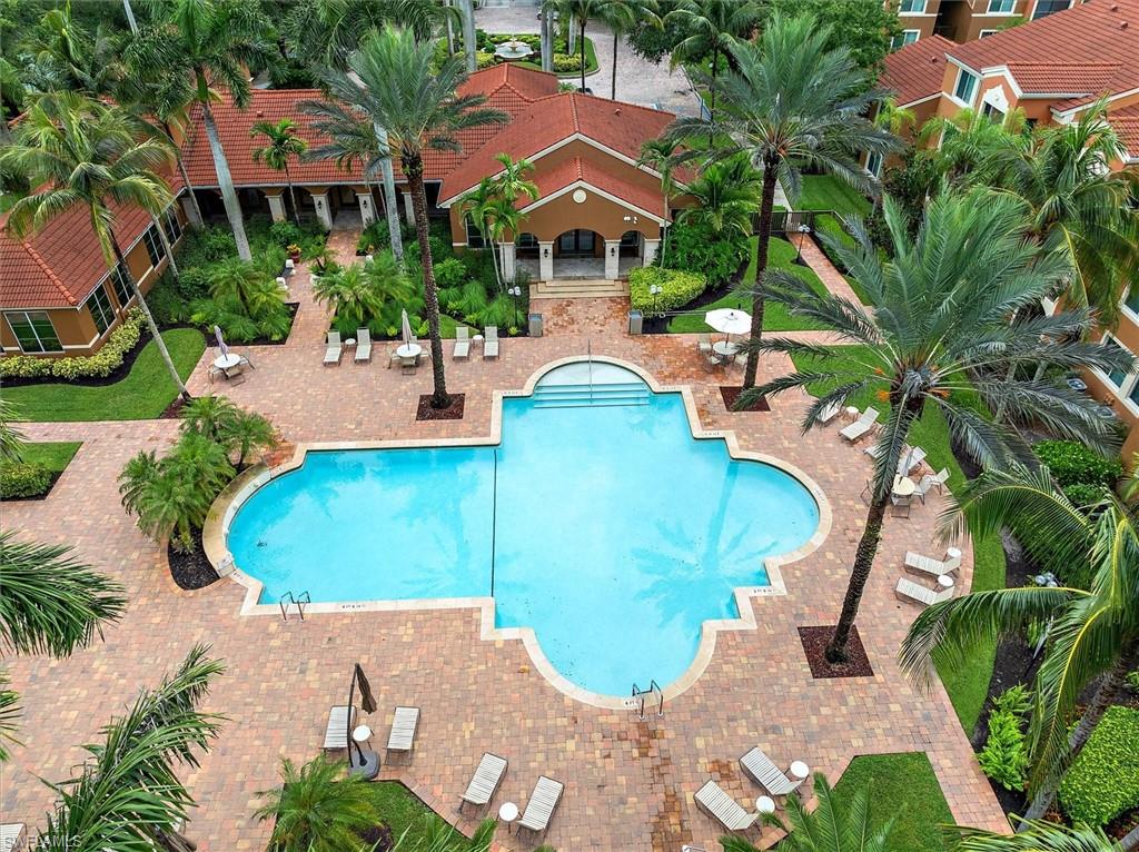 1170 Reserve Way, Unit 107 Naples, FL 34105 - Photo 33 of 47 Community pool featuring a patio
