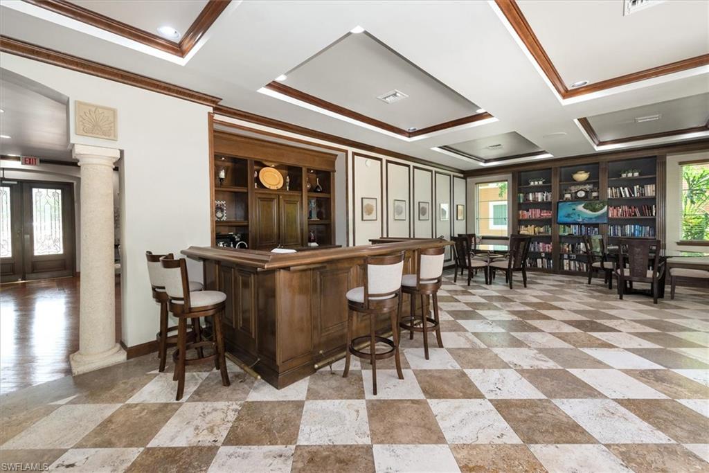 1170 Reserve Way, Unit 107 Naples, FL 34105 - Photo 35 of 47 Indoor dry bar featuring french doors, crown molding, coffered ceiling, and a tray ceiling