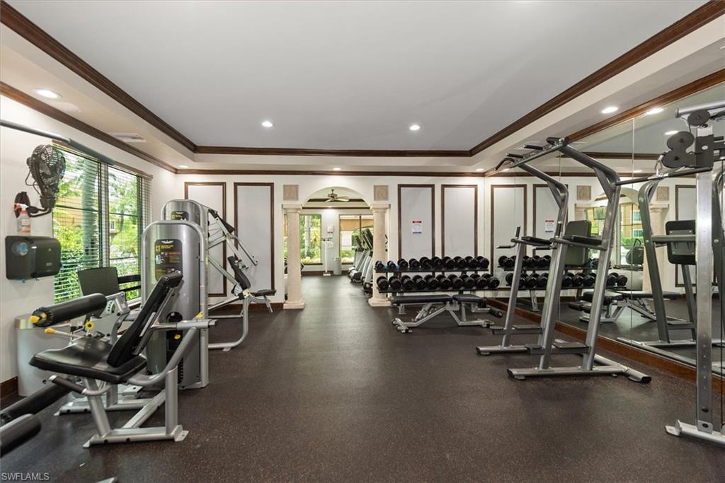 1170 Reserve Way, Unit 107 Naples, FL 34105 - Photo 36 of 47 Exercise room featuring crown molding, arched walkways, a raised ceiling, and recessed lighting
