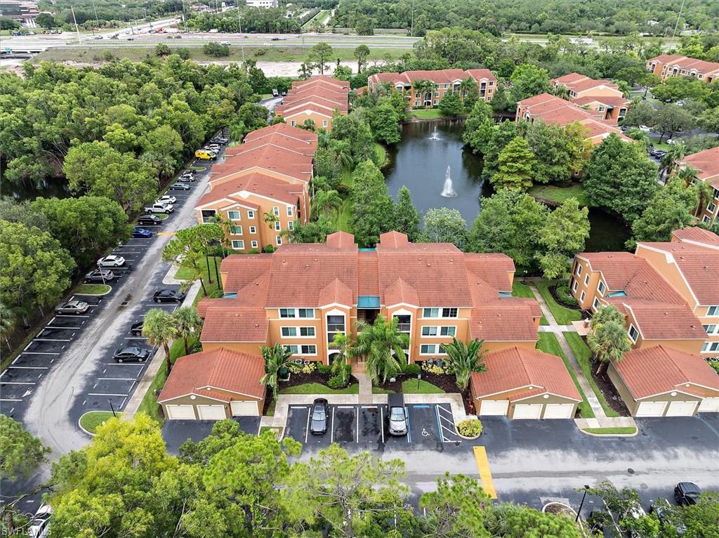 1170 Reserve Way, Unit 107 Naples, FL 34105 - Photo 42 of 47 Aerial view of a nearby body of water and apartment complex