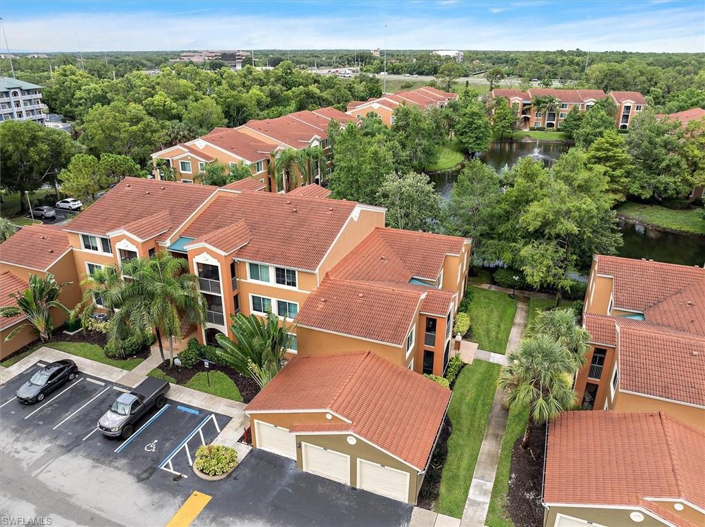 1170 Reserve Way, Unit 107 Naples, FL 34105 - Photo 45 of 47 Aerial view of residential area with a large body of water and apartment complex / building